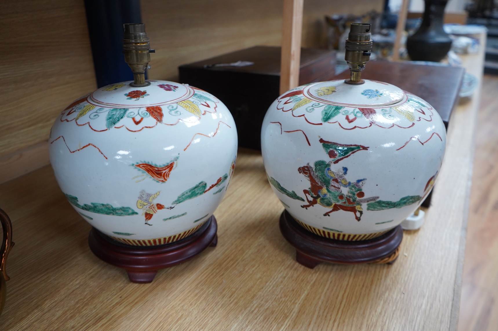 A pair of Chinese jar and covers on stands, converted later to lamps, 34cm including fittings.